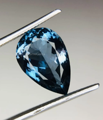 JLUXS PEAR CUT 7X10MM LONDON BLUE TOPAZ (VS) LOOSE GEMSTONE