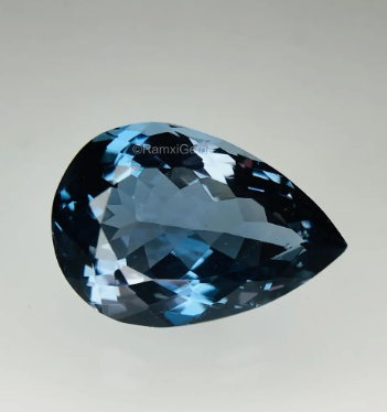 JLUXS PEAR CUT 7X10MM LONDON BLUE TOPAZ (VS) LOOSE GEMSTONE
